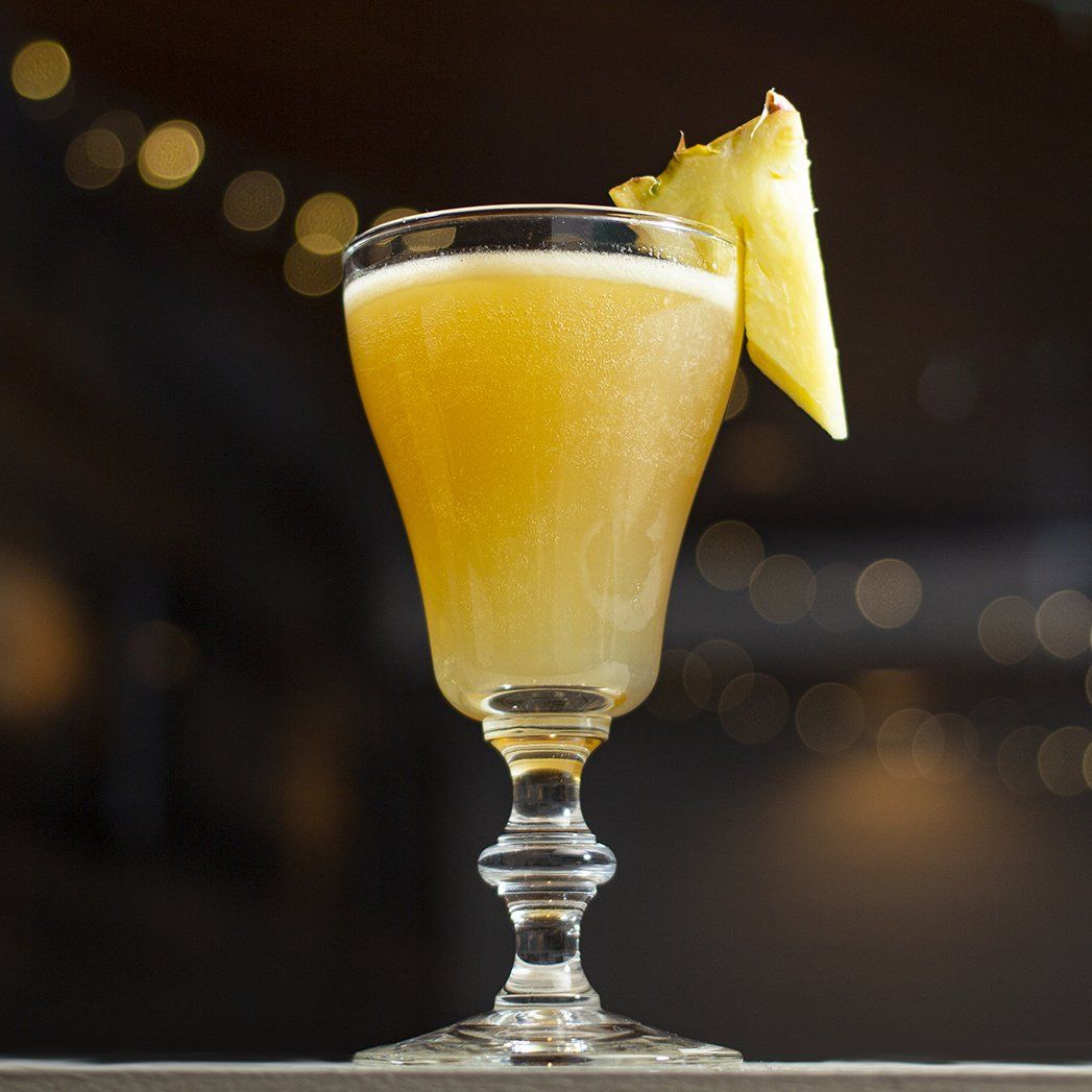 House pineapple daiquiri garnished with a pineapple wedge