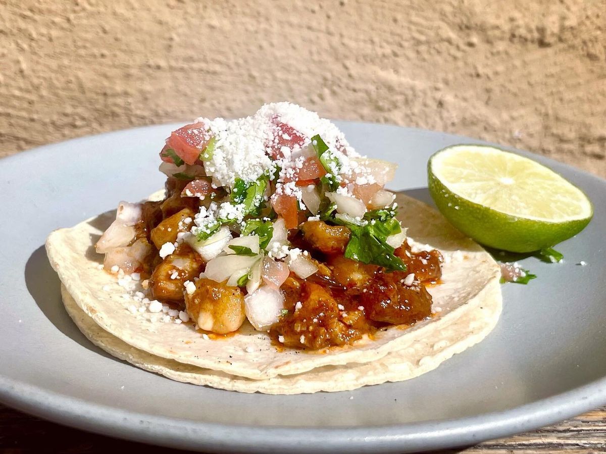 Street taco with cotija and a lime wedge